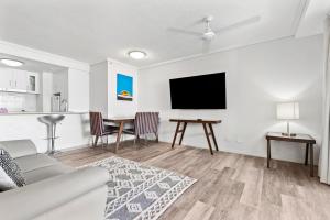 a living room with a couch and a table at Cairns Central Plaza Apartment Hotel in Cairns