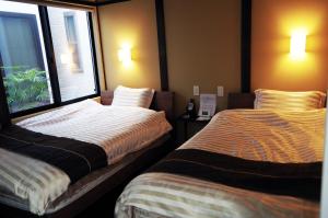 A bed or beds in a room at Uji-Ichibanyado-Nigauri