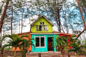 a colorful house in the middle of a forest at Villa Uda @ SIBLINGS Cottage in Setiu