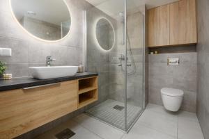 a bathroom with a sink and a shower at MY Residence in Pärnu