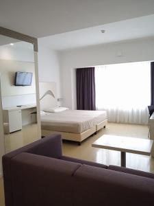 Letto o letti in una camera di Hotel Poseidon