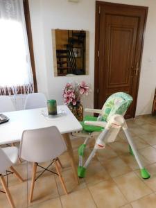 a green and white chair sitting next to a table at Villa Dima in Paleo Tsifliki +70 photos