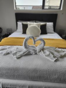 - une décoration cardiaque au-dessus d'un lit dans l'établissement Quality Stay Private Guest Room in Auckland, à Auckland