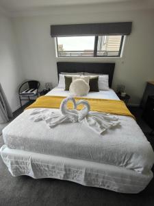 a bedroom with a bed with two hearts on it at Quality Stay Private Guest Room in Auckland in Auckland