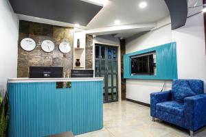 a lobby with a blue counter and a blue chair at Dream Hotel - Richmond in Bangalore