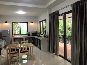 a kitchen with a table and chairs and a balcony at Thai Terrace Bungalow in Thong Nai Pan Yai +51 photos