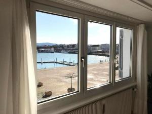 a window with a view of a body of water at Apartment Romanshorn von Swisspartments in Romanshorn