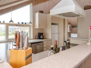 a kitchen with a counter and a large window at 7 person holiday home in Harbo re in Harboør