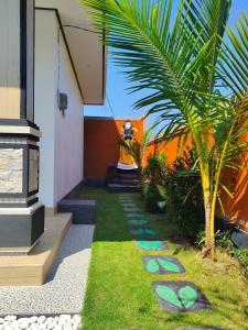 a garden with stepping stones on the grass at Konex homestay in Canggu