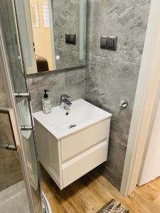 a bathroom with a sink and a mirror at OSTOJA LUSOWO in Lusowo