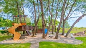 a park with a slide and a playground at Sekuro Village Beach Resort in Jepara