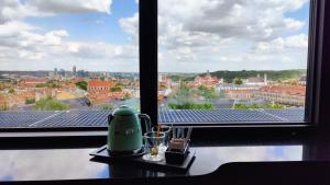 a room with a window with a view of solar panels at Hotel Panorama in Vilnius