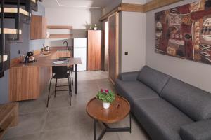 a living room with a couch and a table at Apertura Minima Living space next to sea in Kalamata