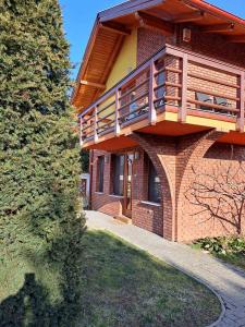 a building with a balcony on the side of it at Rozmaring Apartmanok in Gyula