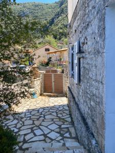 un edificio de piedra con una ventana y una puerta en Дом для дружной семьи, en Mikros Gialos