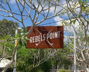 a sign for a reels point sign in a tree at Rebels Point in Jimbaran