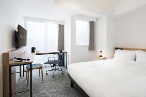 Postel nebo postele na pokoji v ubytování Tokyu Stay Shibuya Shin-Minamiguchi