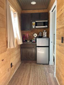 a small kitchen with a refrigerator and a microwave at Area 3251 Desert Valley Guest Suite in Pahrump