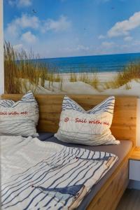 a bed with pillows sitting on top of a beach at Appartement "Sonnenperle" in Heiligenhafen