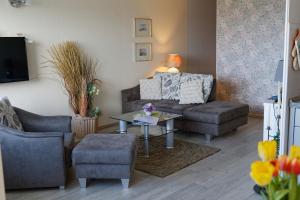 a living room with a couch and a table at Appartement "Sonnenperle" in Heiligenhafen