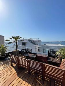 a deck with benches and a view of the ocean at 葉山THE TERRACE HOUSE in Hayama