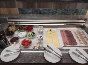 a counter with different types of meats and other foods at Santa Maria City Hotel in Rhodes Town +20 photos
