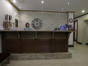 a woman standing behind a bar in a restaurant at Nil Hotel in Istanbul