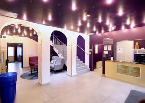 a room with a staircase and a stair case with lights at Das Schreder Hotel in Munich