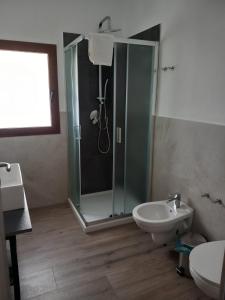 a bathroom with a shower and a toilet and a sink at Turismo Rurale Lu Stazzu Arzachena in Arzachena