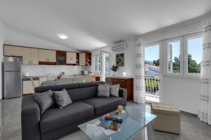 a living room with a couch and a kitchen at Ana Apartment in Makarska