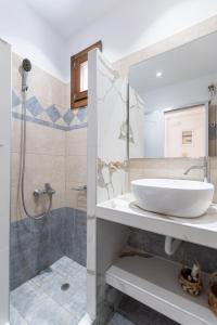 a bathroom with a sink and a shower at Amaranto Naxos 2 in Naxos Chora