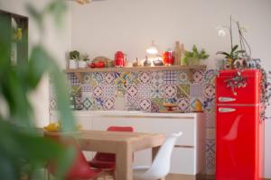 a kitchen with a table and a red refrigerator at Indarsena b&b in Portoferraio +81 photos