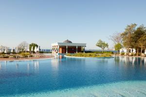 a large pool of water in front of a building at Dreams Sunny Beach Resort and Spa - Premium All Inclusive in Sunny Beach