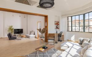 a living room with a couch and a table at Renovated Historical Roof Top Apt by the Beach in Tel Aviv