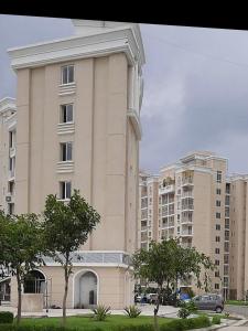 a large building with trees in front of it at Omaxe eternity in Vrindāvan