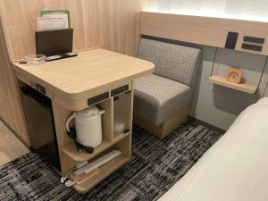 a small room with a desk and a bed at R&B Hotel Ueno Hirokoji in Tokyo