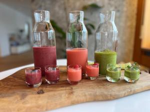 a group of different colored juices in glass bottles at Unsereins Hotel in Bad Steben