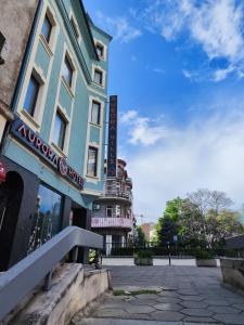 a building with a sign on the side of it at Aurora Hills Hotel in Plovdiv