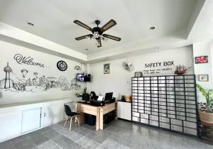an office with a desk and a ceiling fan at NN Apartment in Pattaya South