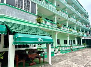 an outside view of a hotel with an awning at NN Apartment in Pattaya South
