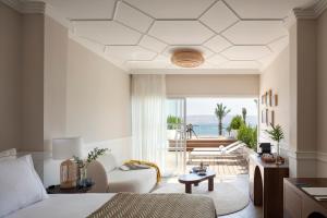 a bedroom with a bed and a view of the ocean at Galei Kinneret Hotel in Tiberias