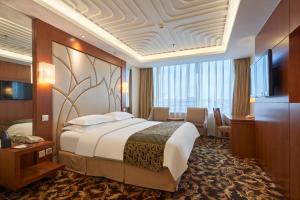 Ένα ή περισσότερα κρεβάτια σε δωμάτιο στο Howard Johnson Paragon Hotel Beijing Centra Provide tourism and ticketing service
