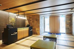 a restaurant with a counter and a table and chairs at MONday Apart Premium UENO in Tokyo
