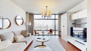 a living room with a couch and a table at Primestay - Index Tower 1Br in DIFC in Dubai