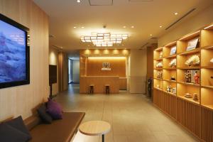 a salon with a waiting room with a waiting table at hotel MONday Tokyo Nishikasai in Tokyo
