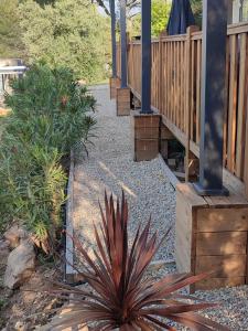 a garden with a walkway and a patio at LUXUEUX MOBIL-HOME in Pierrefeu-du-Var