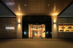 an entrance to a building at night at Super Hotel Shikoku-chuo in Shikokuchuo