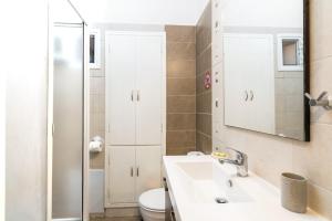 a bathroom with a sink and a toilet at Tenedos old town in Corfu Town +33 photos