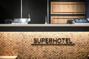 a counter with two laptops on top of a wall at Super Hotel Shikoku-chuo in Shikokuchuo