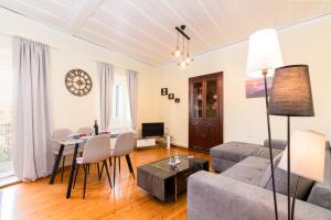 a living room with a couch and a table at Tenedos old town in Corfu Town